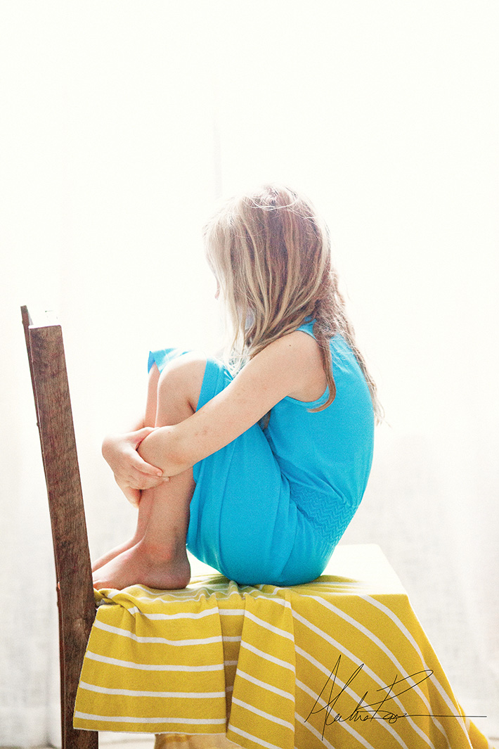 Photo of Girl in Blue on Yellow Blanket