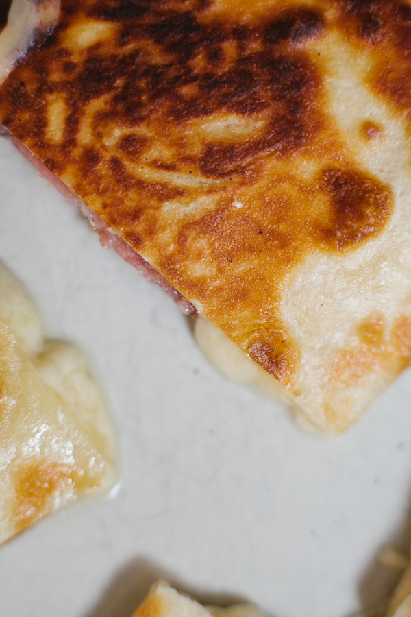 Melting cheese in a salami quesadilla