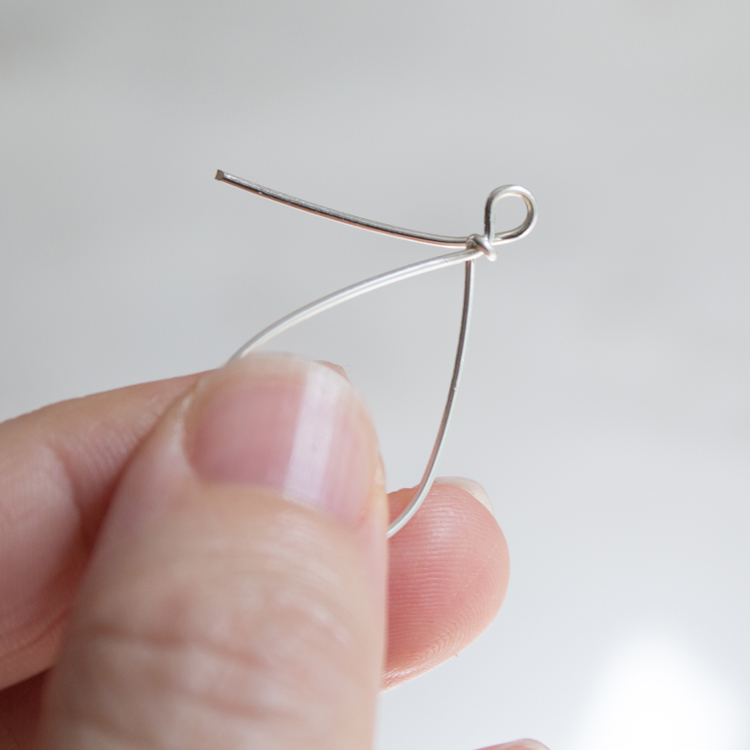 Cross the wire behind the earring