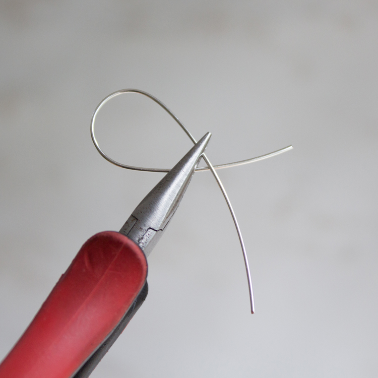 Grasp both wires tightly