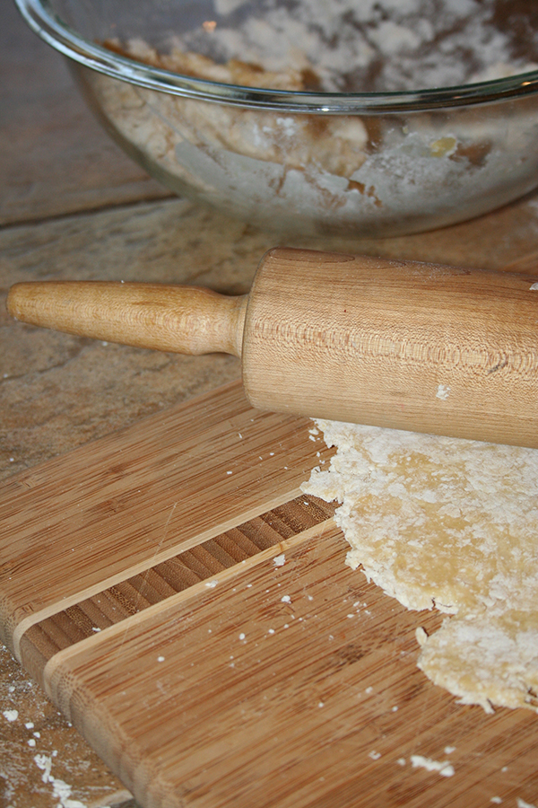 Roll pasta dough with a rolling pin