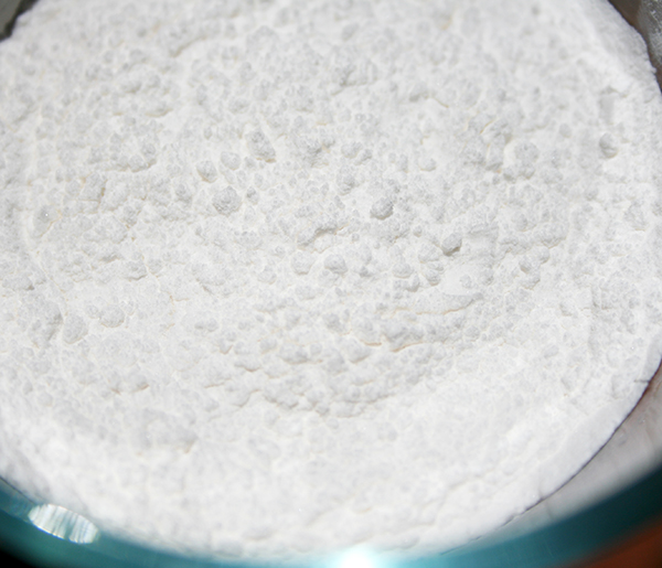 Sifting cream of tartar and baking soda to make DIY baking powder