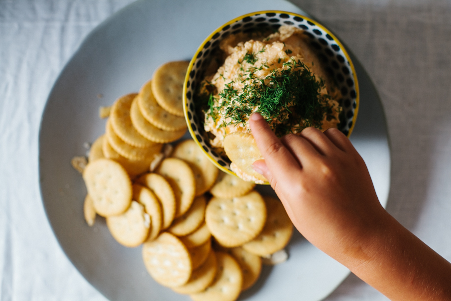 eager hands in cheese dip