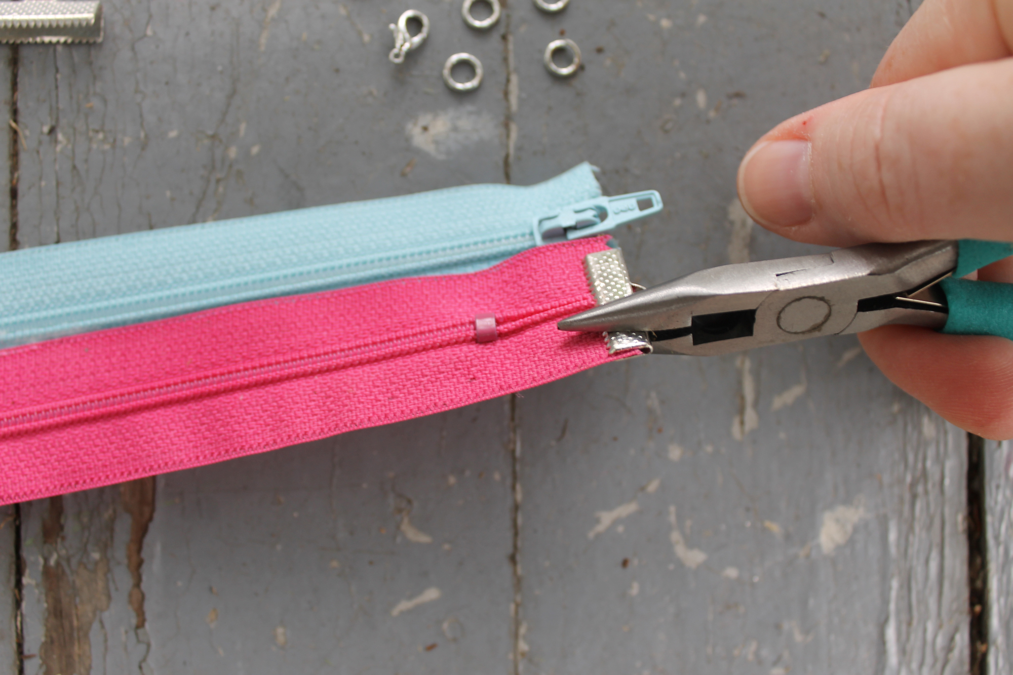 Clamping the ribbon ends around the zipper bracelet