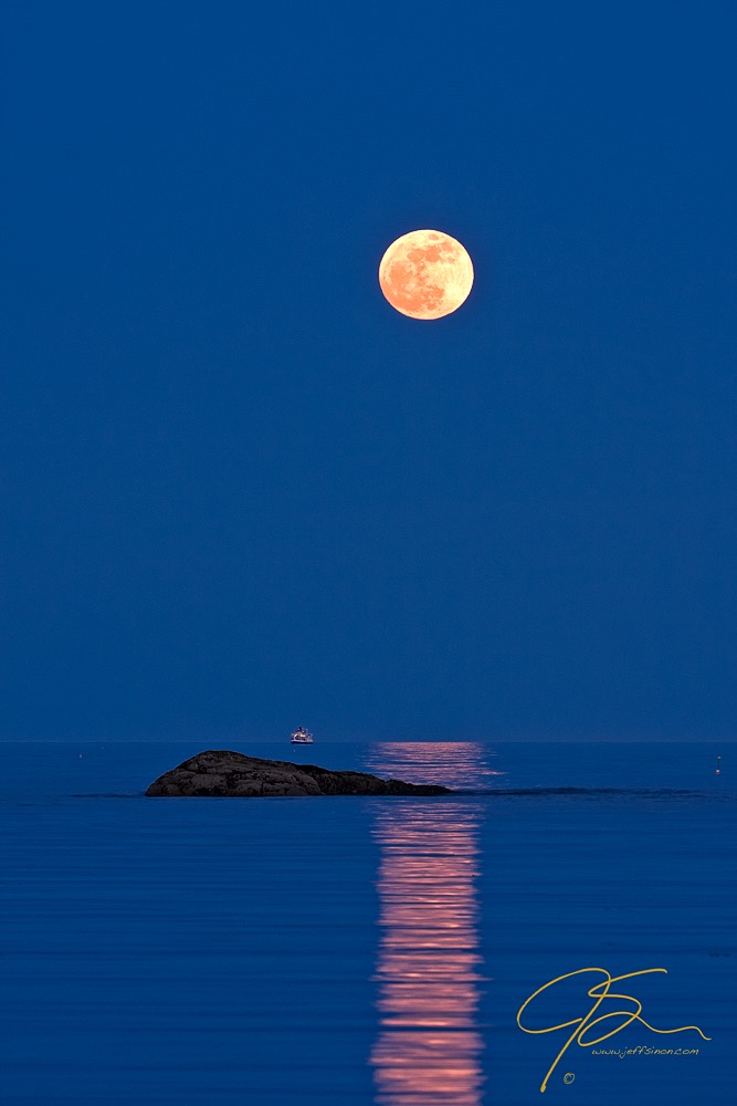 Full moon over an Isles Of Shoals Steamship company cruise ship off the coast of New Hampshire