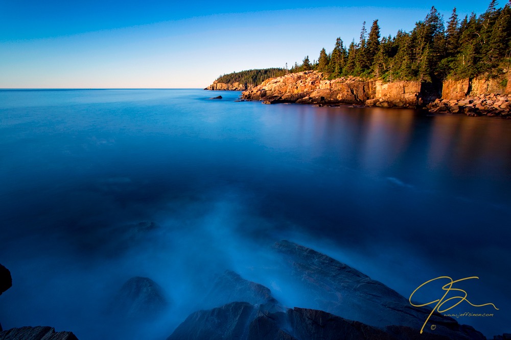 A 3 minute exposure blurs the surface of the ocean at Monument Cove in Acadia National Park