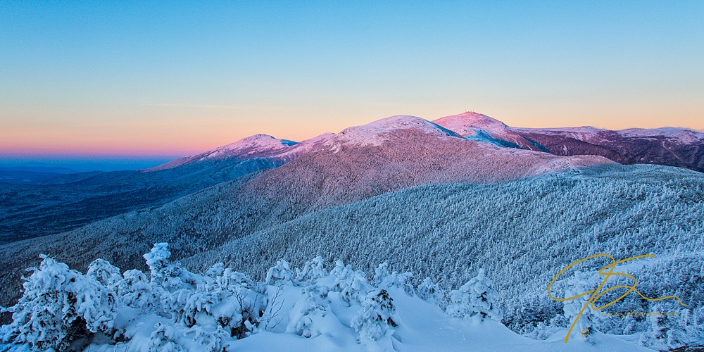 Snow covered Mount Washington bathed in alpenglow