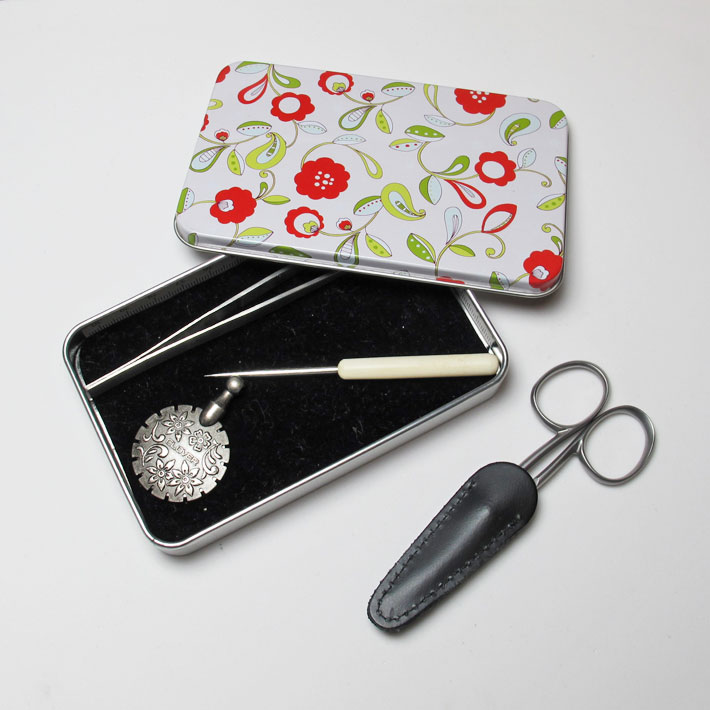 Use a small flat tin to hold extra needlework tools