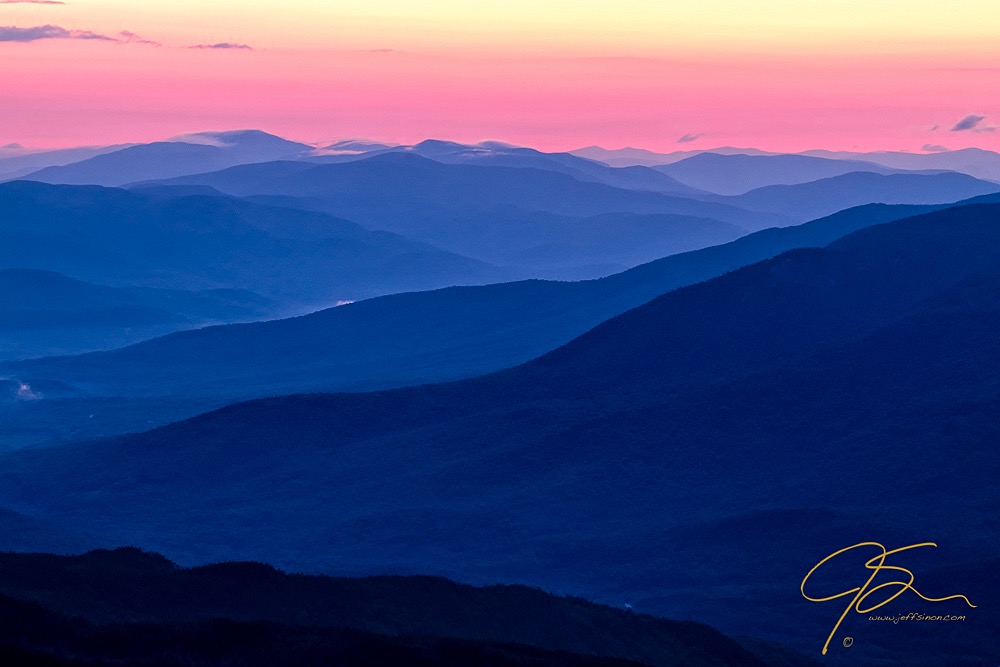 Mountains in the distance in pastel pink and blue layers