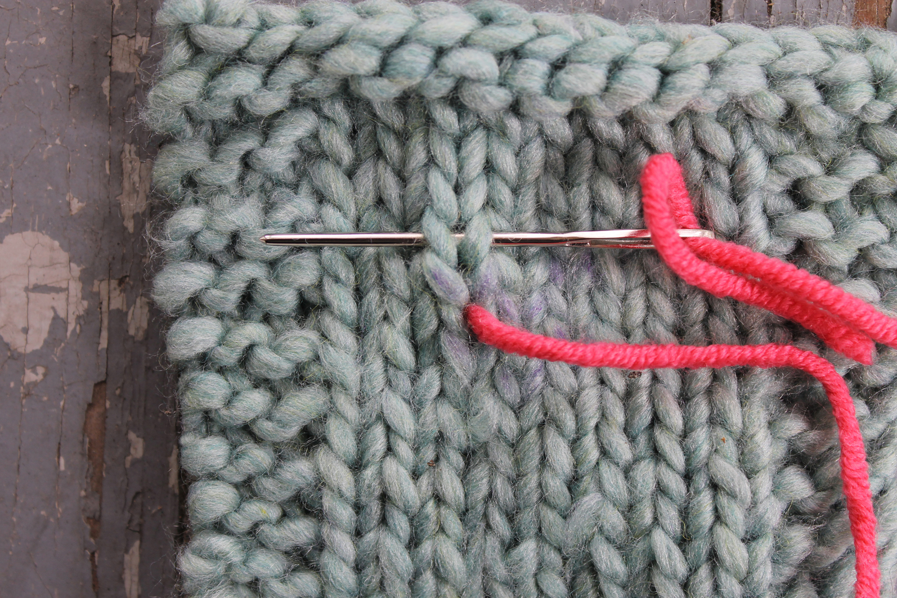 Inserting the needle above the duplicate stitch