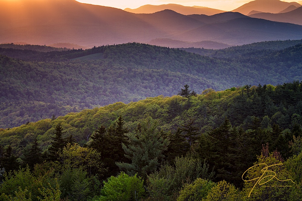 The mountains and forests appear as layers iin the distance.