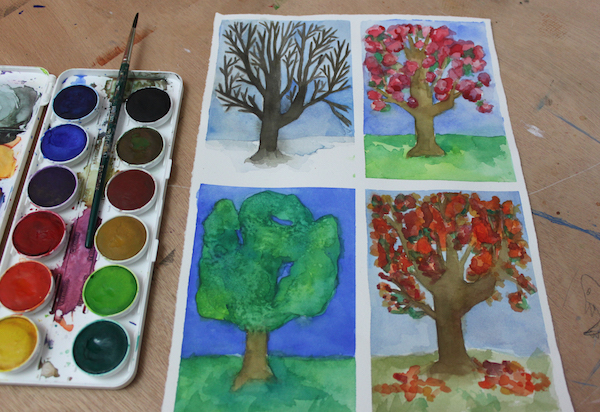 When painting trees in watercolor, their appearance will change based on the time of year.