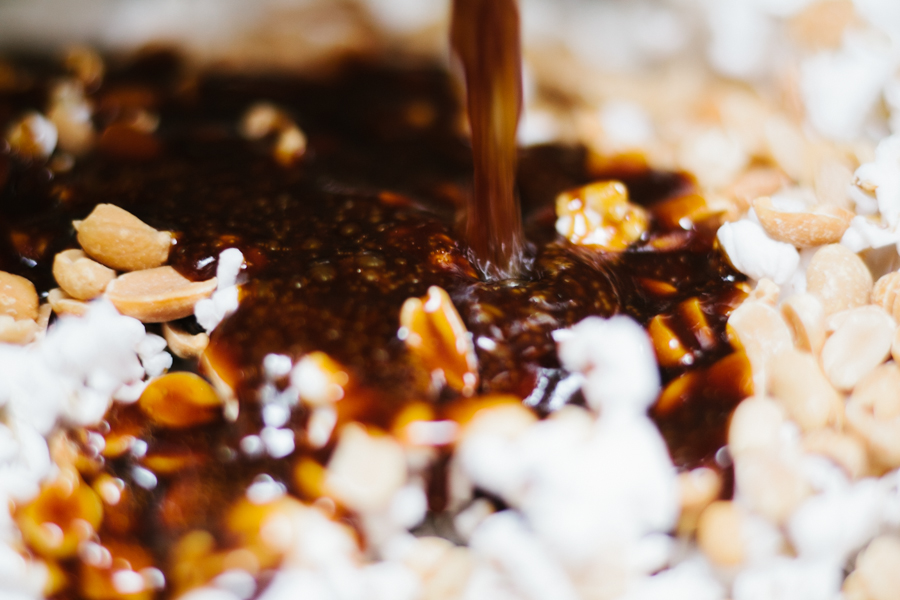 Pouring the toffee over the popcorn for homemade Cracker Jacks