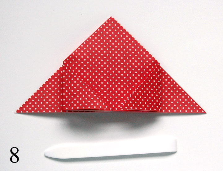 Step 8: Fold in left and right points to center