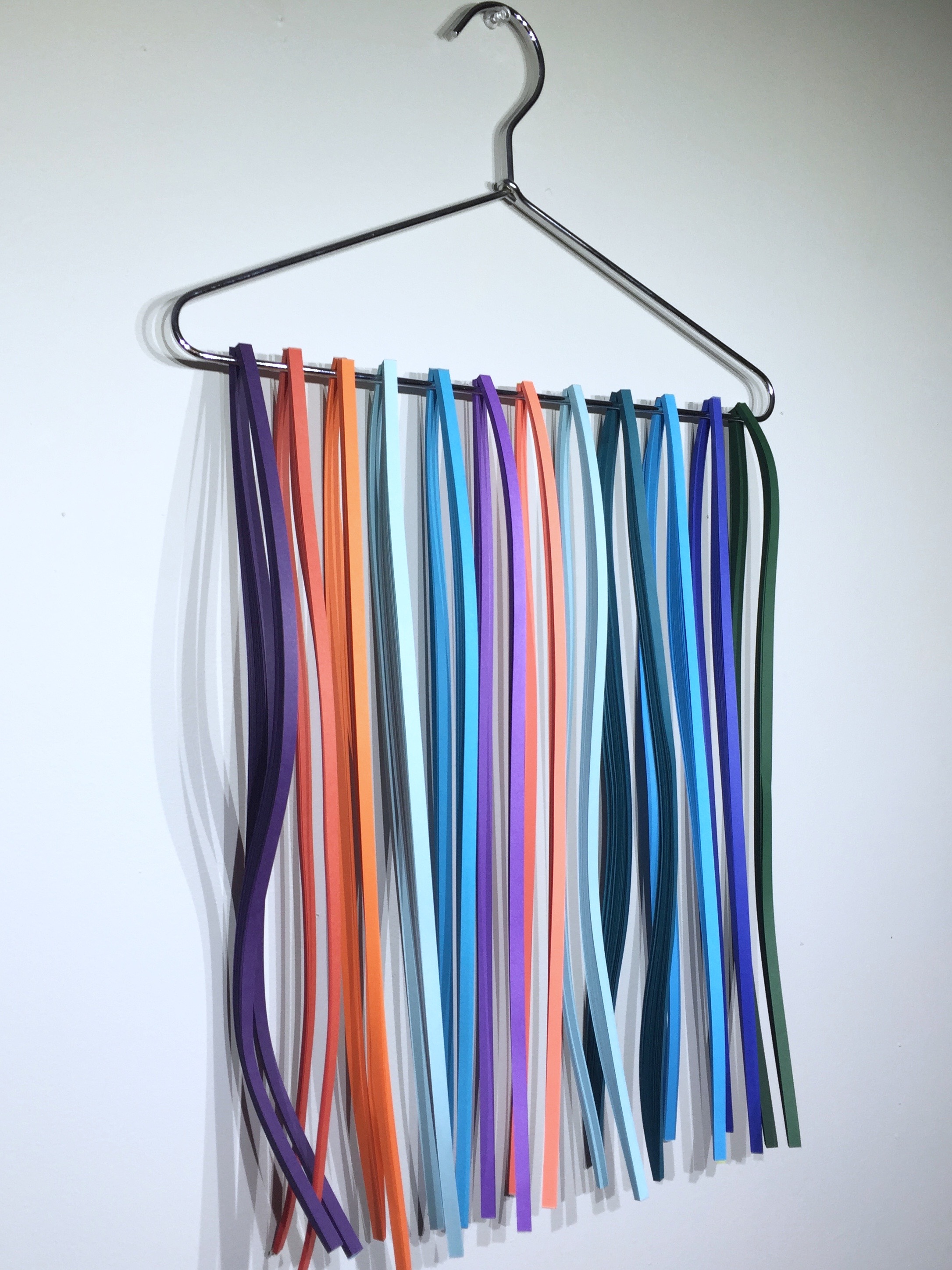 Image of storing quilling paper on a hanger