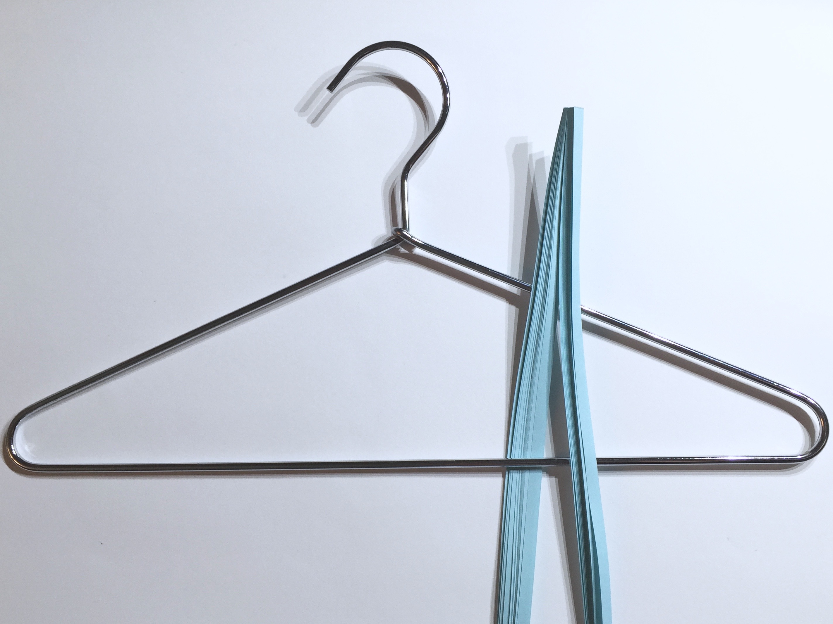 Image of draping quilling paper over a hanger