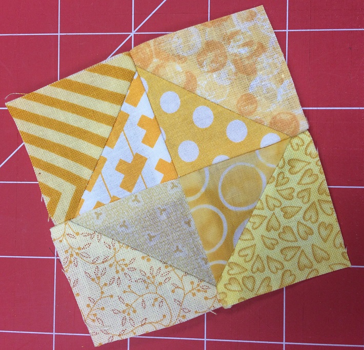 Sew four triangle squares together