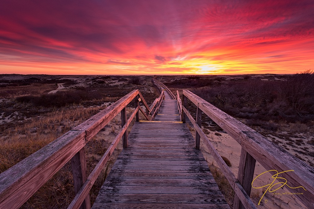 Boardwalk through the sand dunes at sunrise.