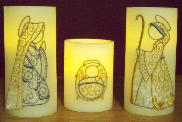 lit nativity embroidery candle