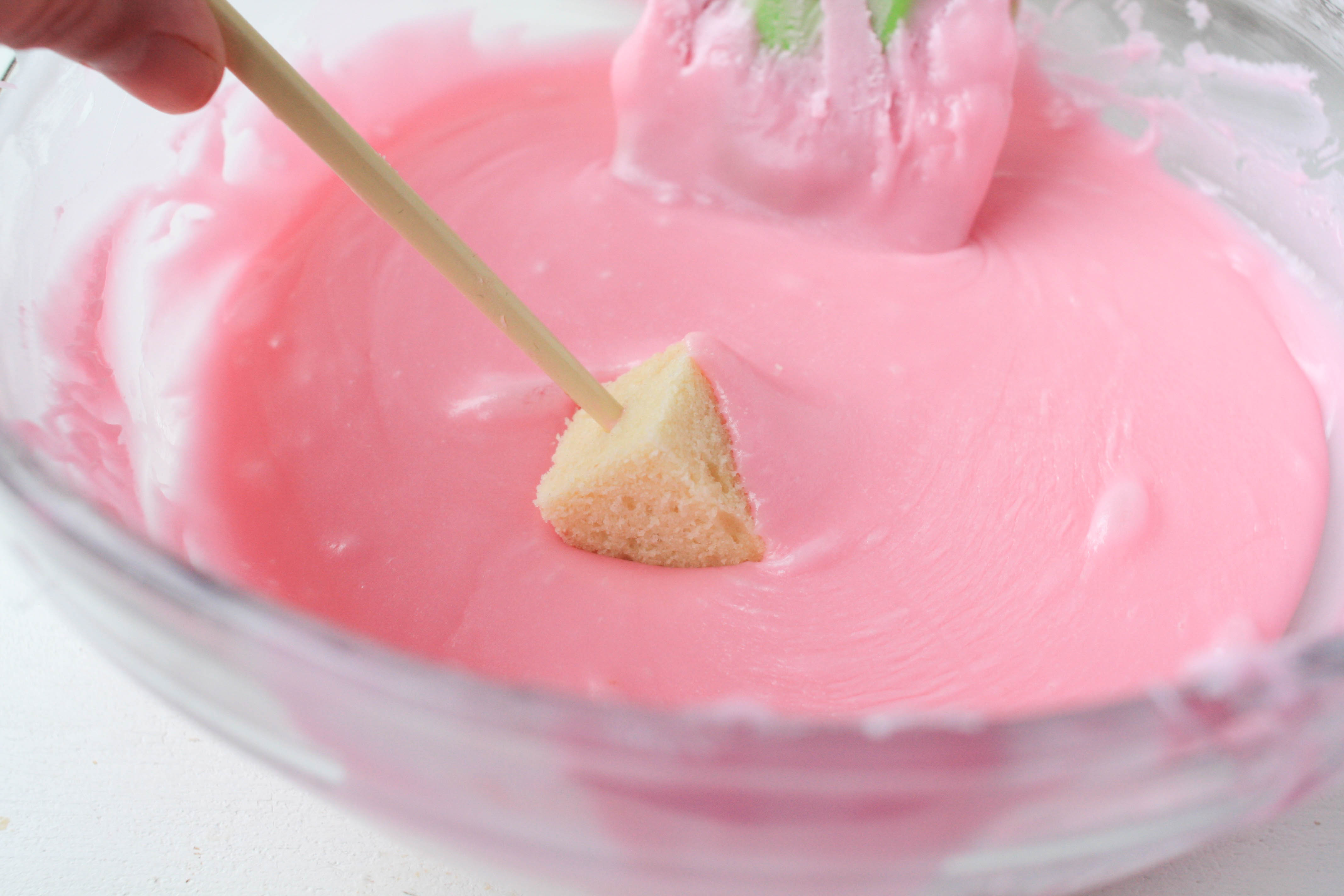 Here's how to dip a petit four in the candy glaze