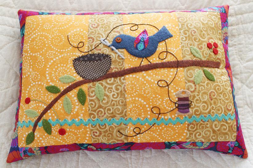 bird on a quilted pillow