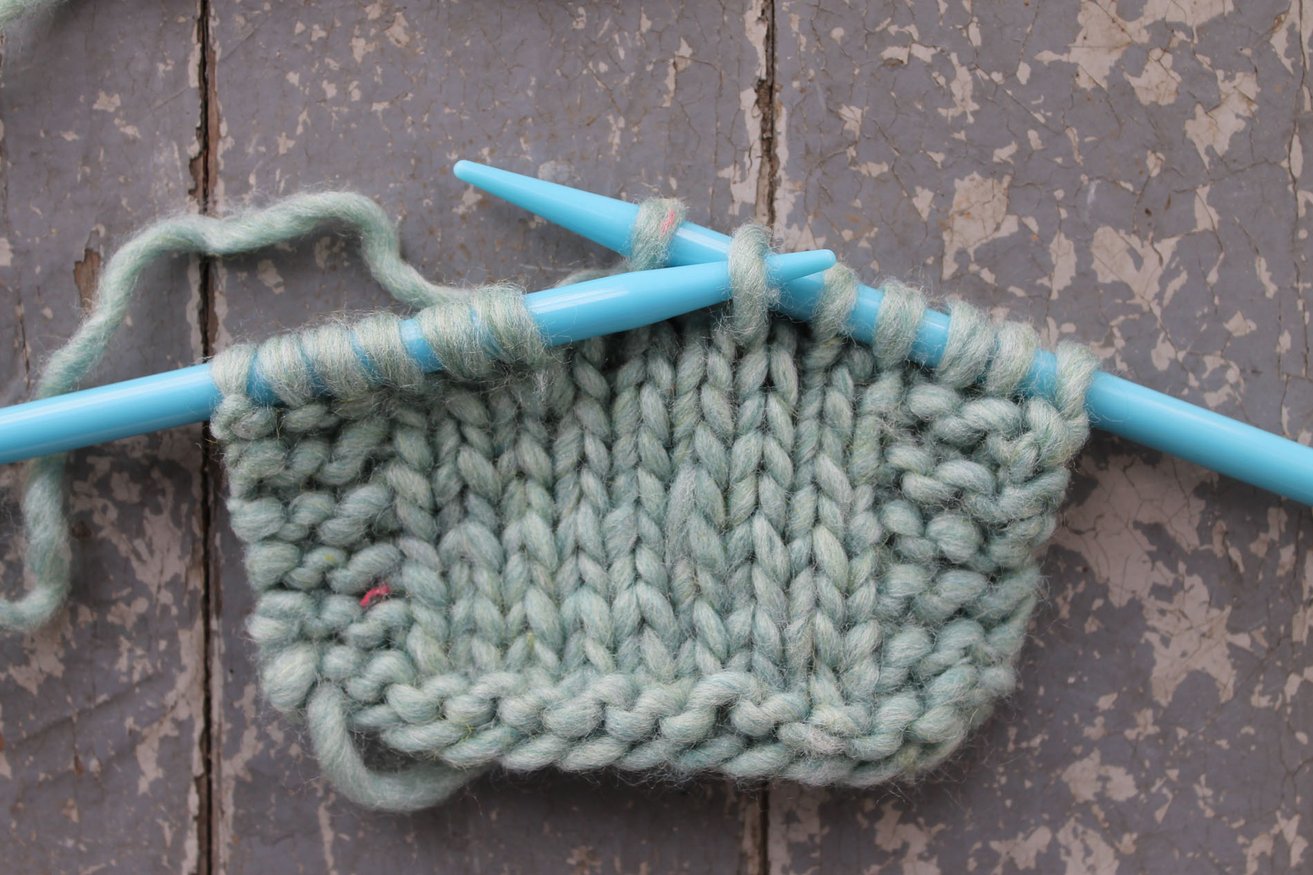 Passing the slipped stitch over