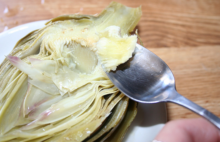 Preparing cooked artichoke to eat