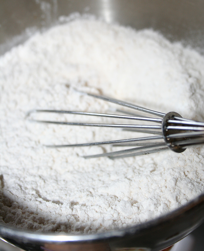 Sifting dry ingredients for homemade animal crackers