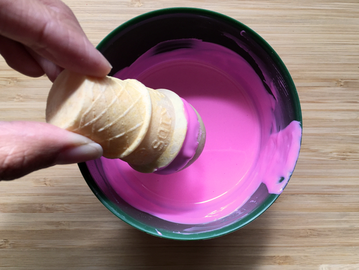 dip the ice cream cone cake pop in melted candy coating