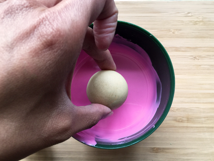 Dunking a Cake Ball in Pink Candy Coating
