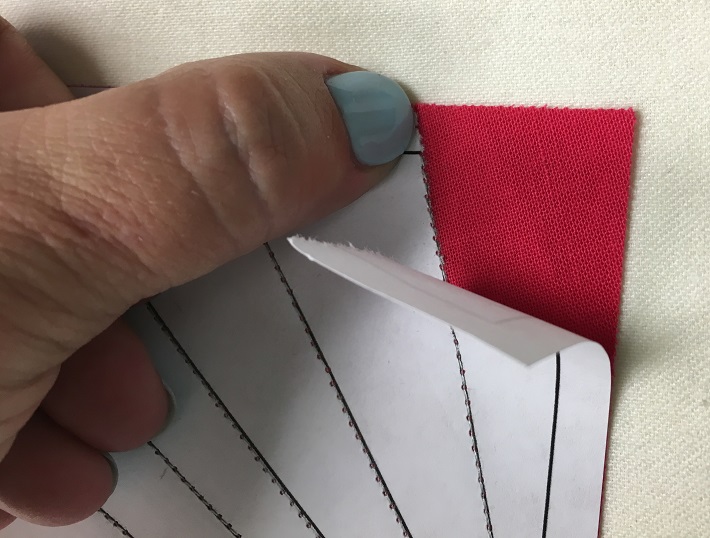 Carefully tearing away the paper