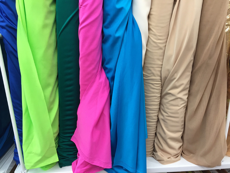 swimsuit fabrics on rack