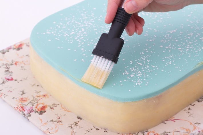 Brush edges of fondant