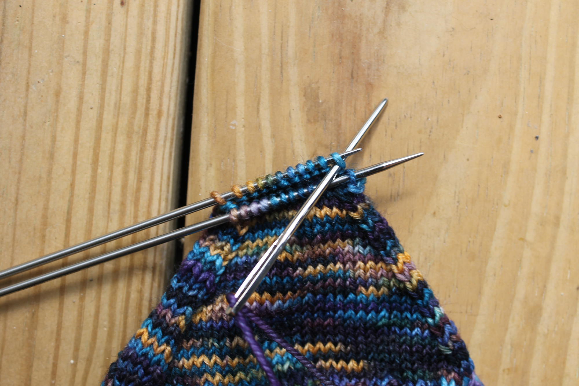 Inserting the needle knitwise on the back needle