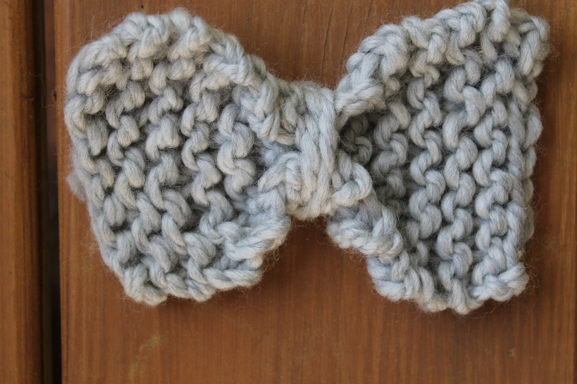 Wrapping yarn around a knit bow