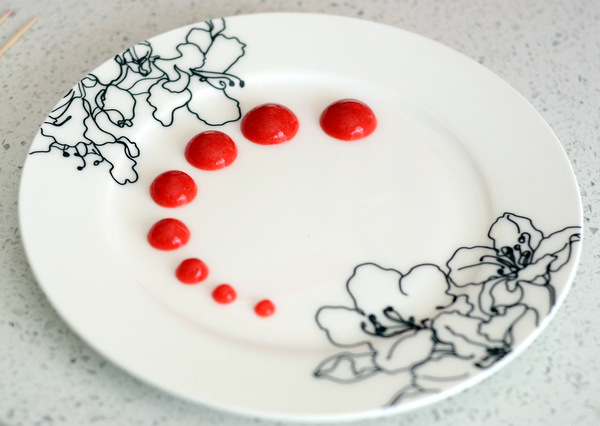 A Plate Decorated With Strawberry Coulis