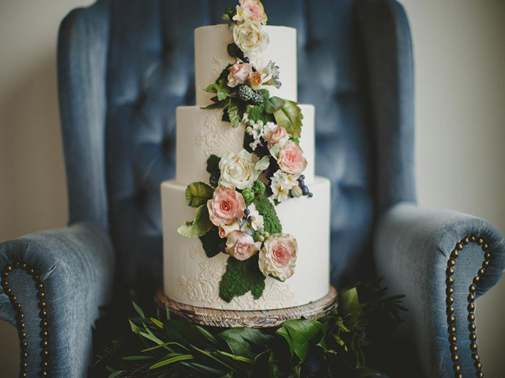 Floral adorned white wedding cake