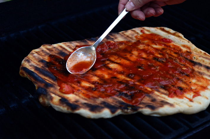 Applying Toppings to Grilled Pizza