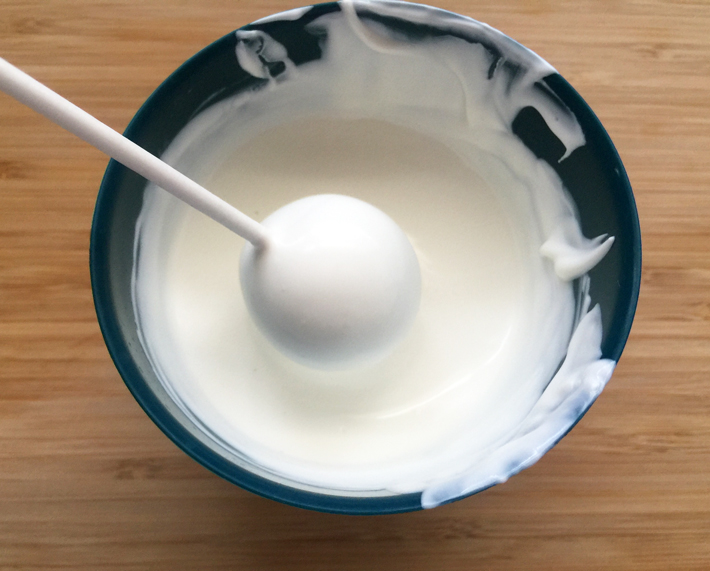 Cake Pop Being Dipped in White Candy Coating