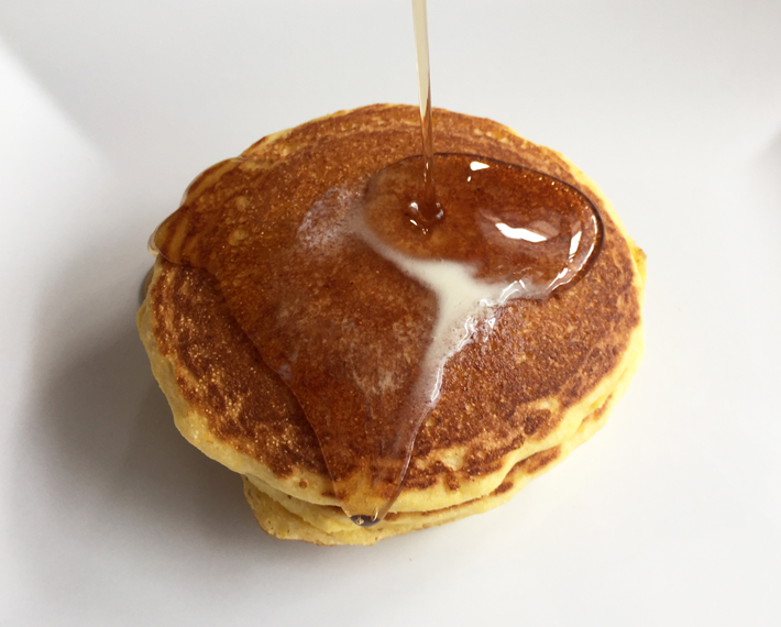 Fresh Cornbread Pancakes Topped With Maple Syrup