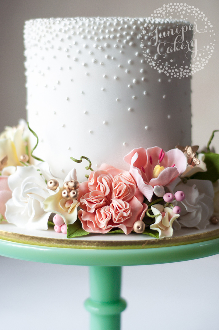 Gold berries and bees on floral cake by Juniper Cakery