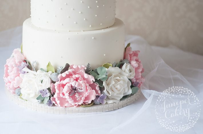 Floral cake with sugar eucalyptus leaves by Juniper Cakery