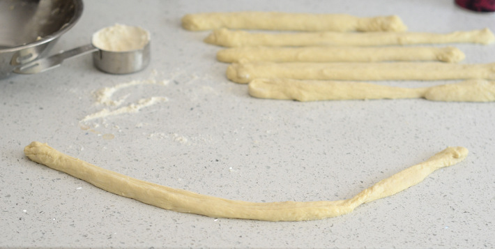 Rope of pizza dough for soft pretzel