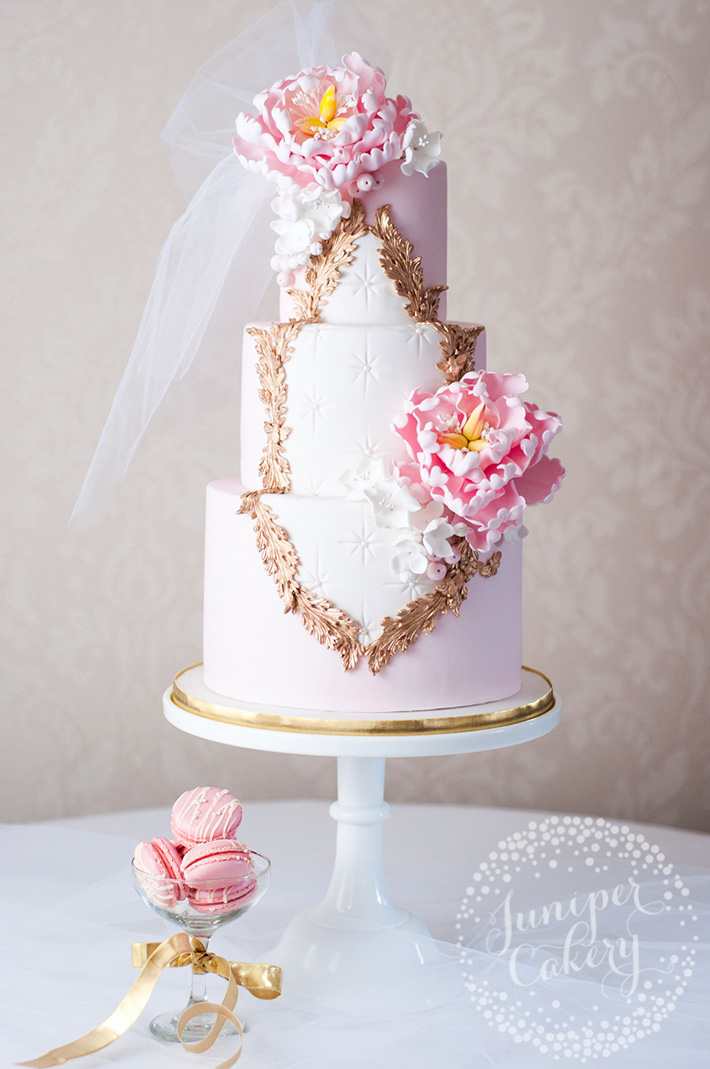 Open peonies on an orange wedding cake by Juniper Cakery