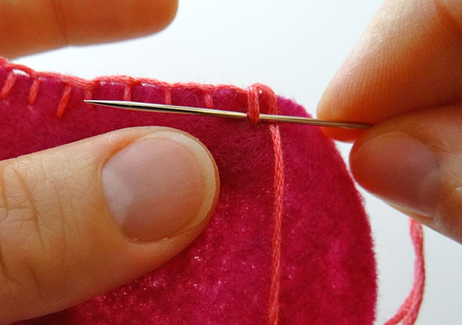Turn over and stitch through thread to start a knot