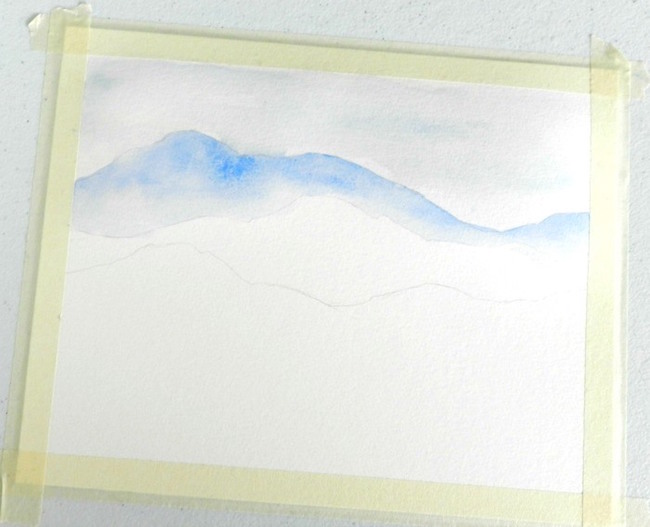 Paint the farthest mountain range in a darker shade