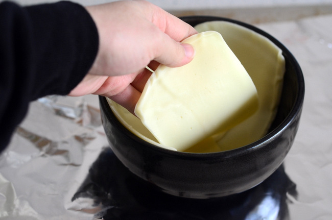 Lining a bowl with cheese for Pizza Pot Pie