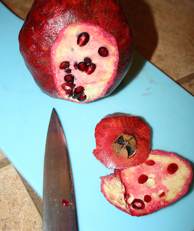 Cut the top and bottom of the pomegranate