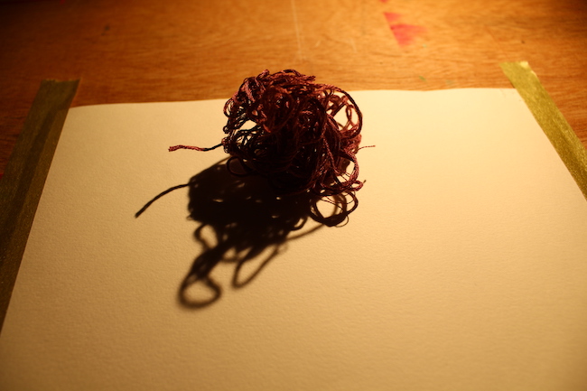 ball of thread with an exaggerated shadow