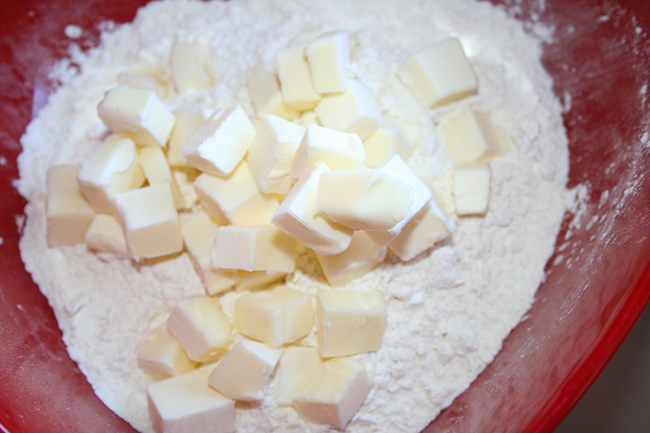 Butter cubes into flour